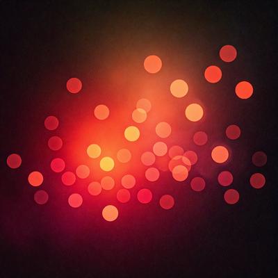 The primary subject of the image is a close-up of a red light source, possibly a light bulb or a neon sign. The setting is a dark background, which emphasizes the red light source. The visual style is a close-up of a single light source, creating a dramatic and intense atmosphere. The colors and mood are predominantly red, with a bold and striking appearance.